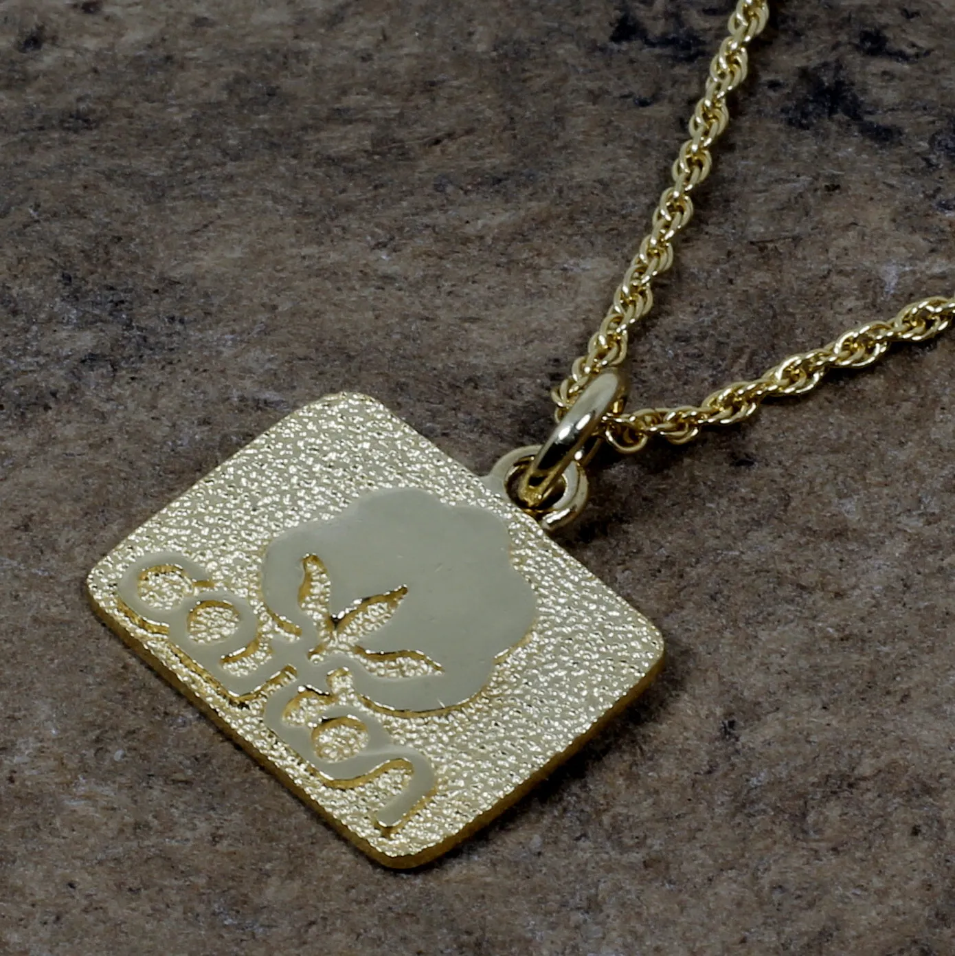 Small Gold Cotton Inc Necklace with Seal of Cotton Logo