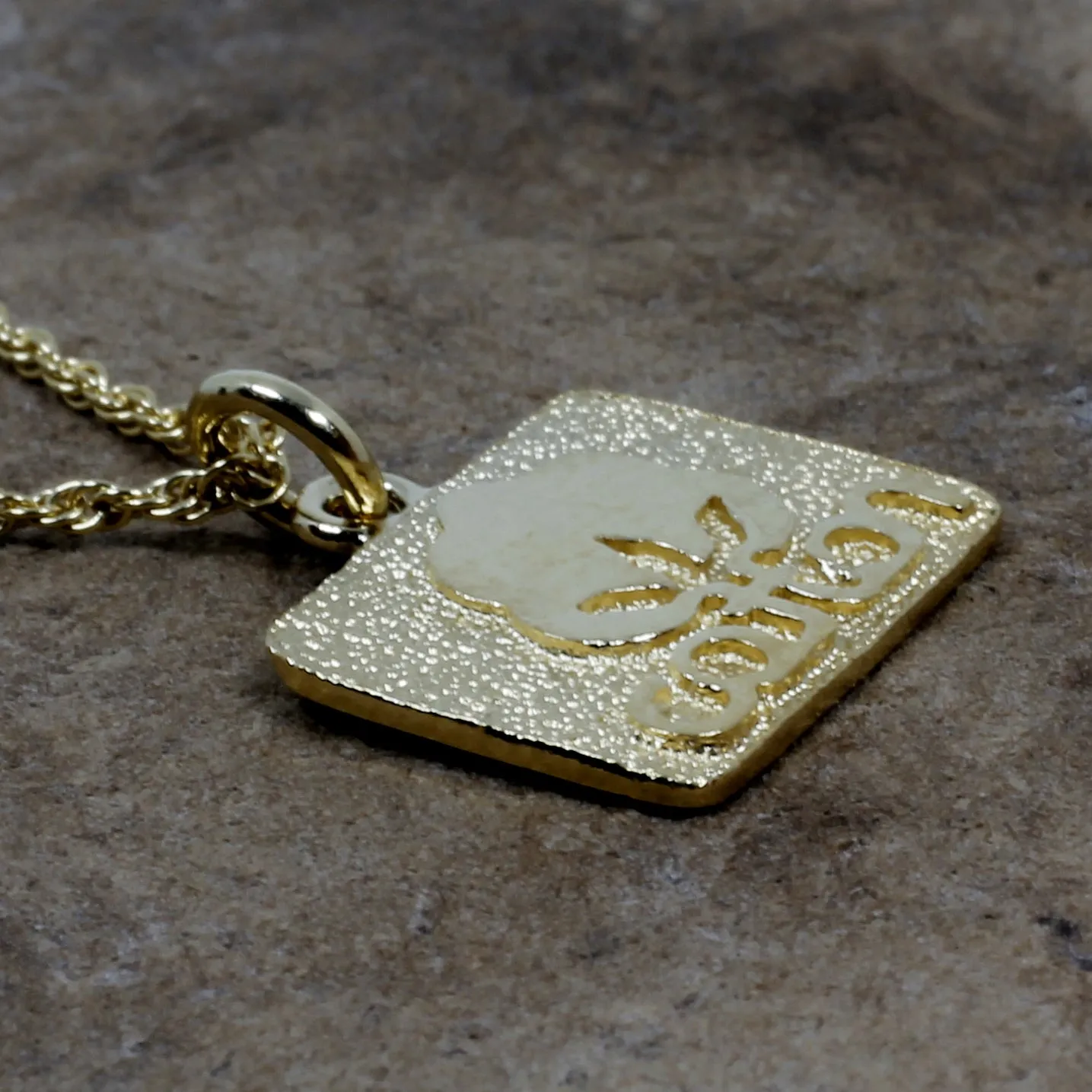 Small Gold Cotton Inc Necklace with Seal of Cotton Logo