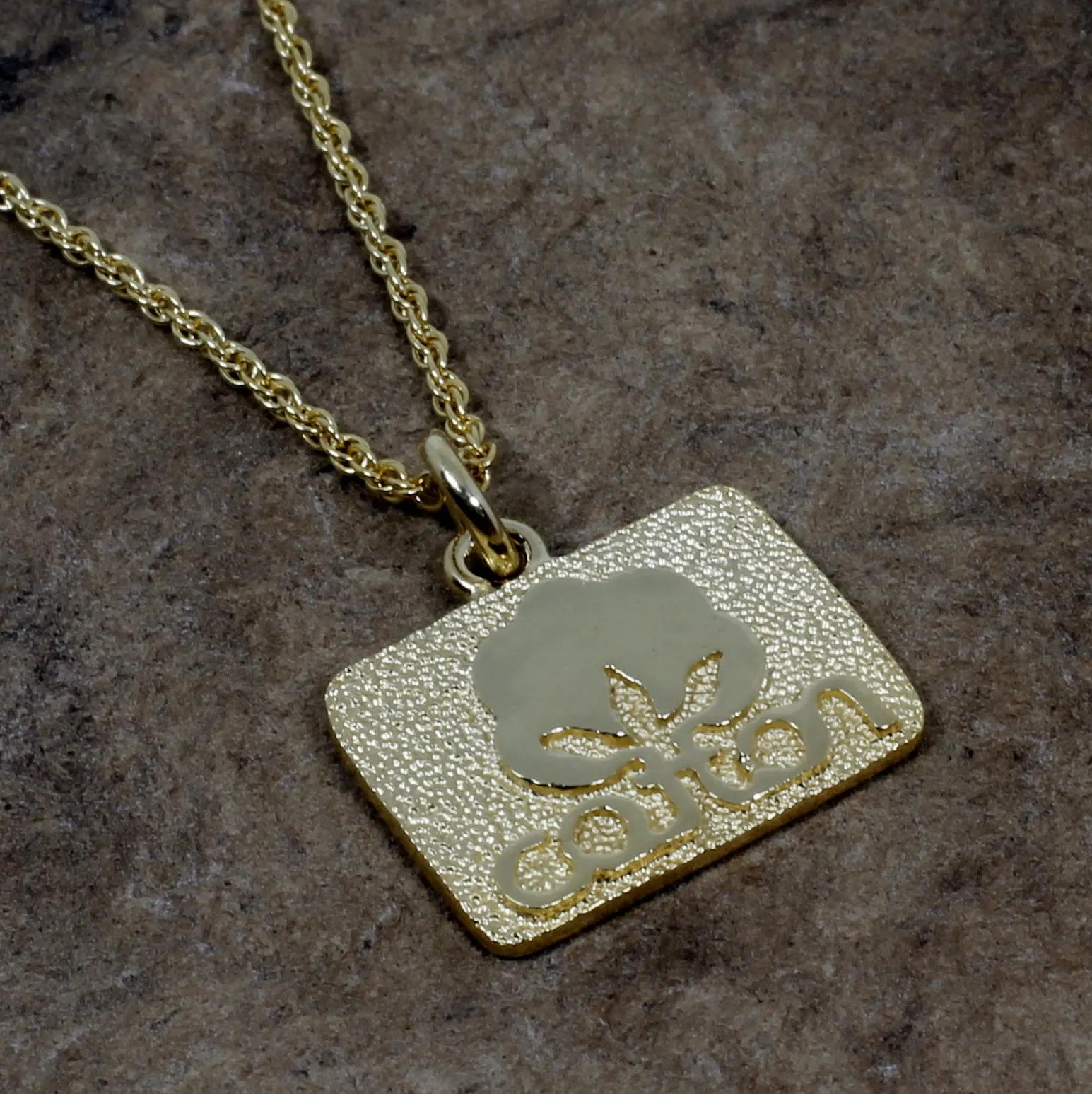Small Gold Cotton Inc Necklace with Seal of Cotton Logo